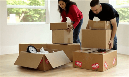 Example of two people moving boxes who use Lee Moving & Storage, Inc.'s moving services